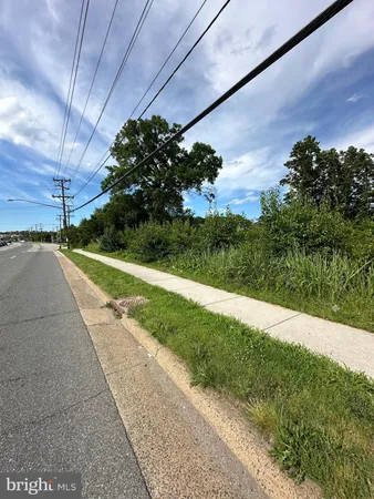 a view of a street with a big yard