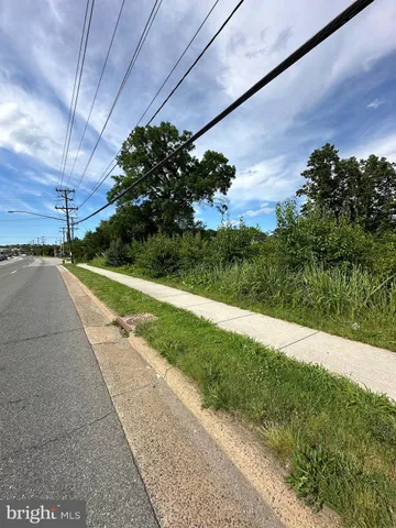 a view of a street with a big yard