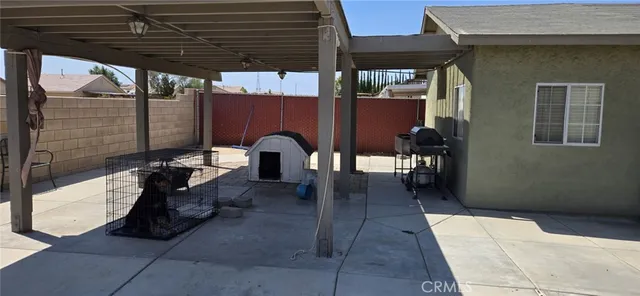 a view of a patio with table and chairs with barbeque and wooden floor