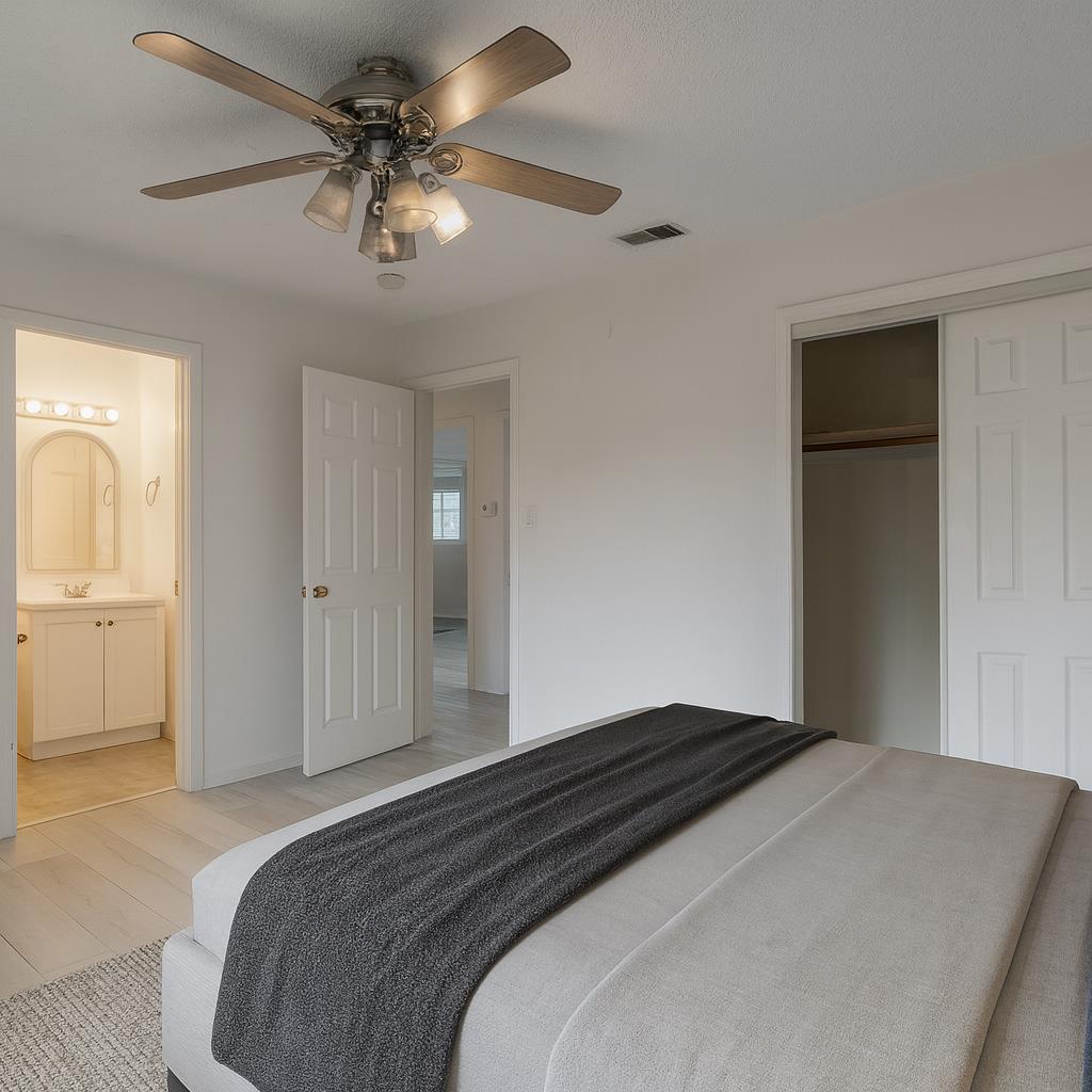 559 Perry Avenue Corcoran, CA 93212 - Photo 6 of 12 a bedroom with a bed and a chandelier