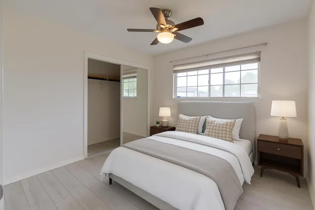 a bedroom with a bed and a window