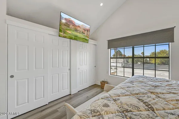 a bedroom with a bed and a large window