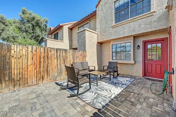 a backyard of a house with barbeque oven table and chairs