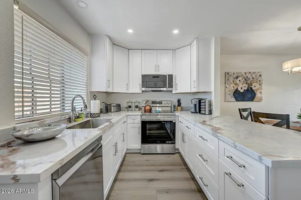 a kitchen with a sink stove and cabinets