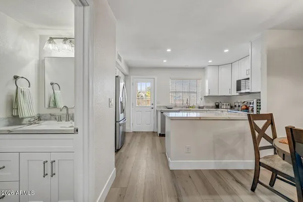 a kitchen with a sink cabinets and wooden floor
