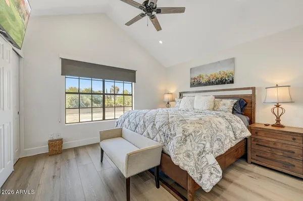 a bedroom with a bed and wooden floor
