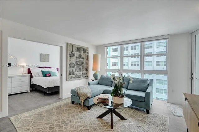 a living room with furniture and a large window