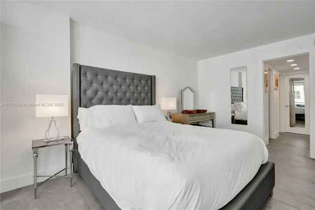 a bedroom with a bed and a night stand