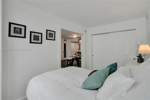 a bedroom with a bed and a large mirror