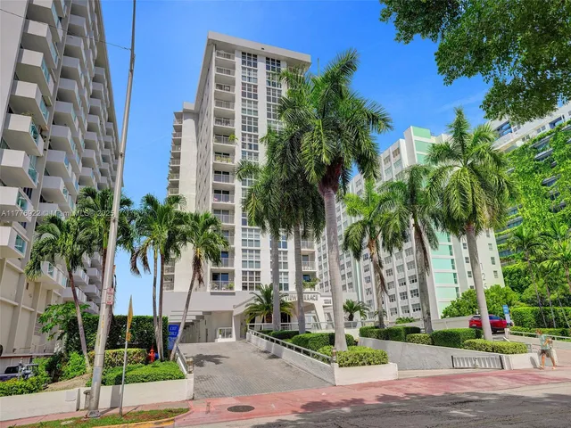 a view of a palm trees in front of a building