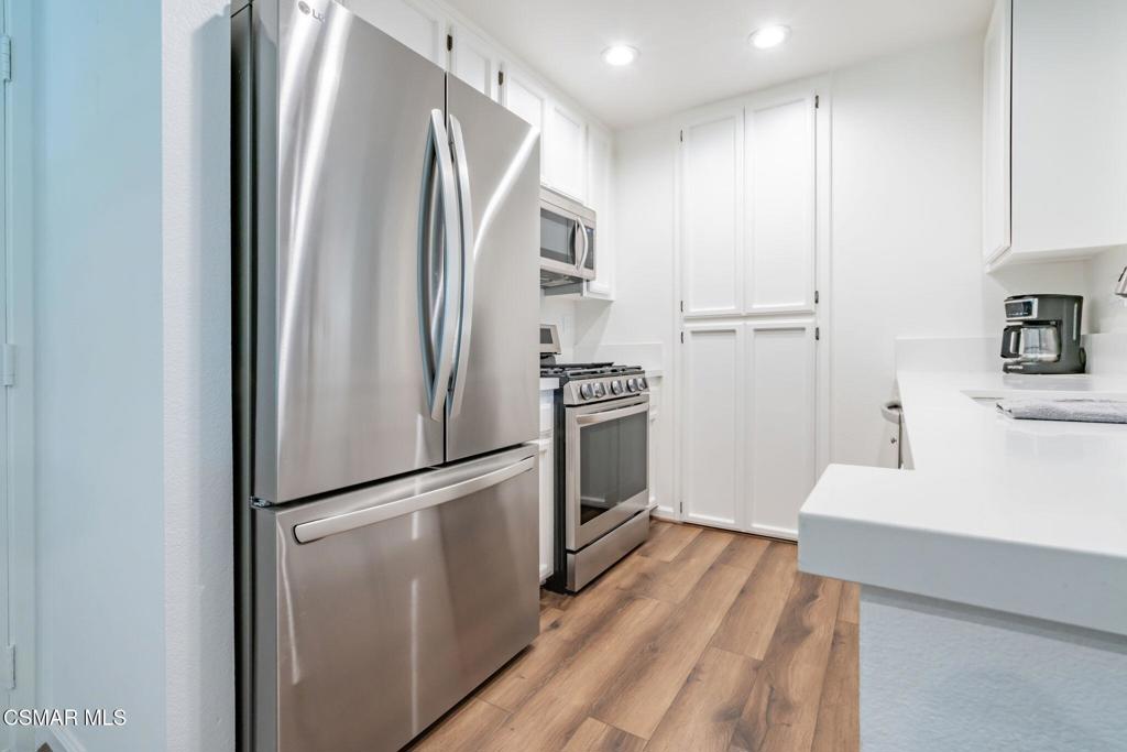 4481 Antigua Way Oxnard, CA 93035 - Photo 13 of 76 a kitchen with stainless steel appliances a refrigerator stove and microwave
