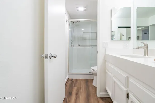 a bed room with a bed and a mirror