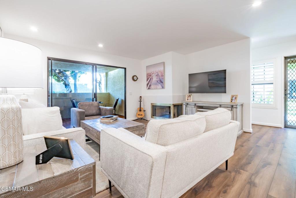 4481 Antigua Way Oxnard, CA 93035 - Photo 35 of 76 a living room with furniture a fireplace and a flat screen tv