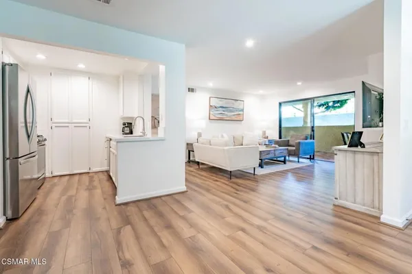 a kitchen with stainless steel appliances a refrigerator stove and microwave