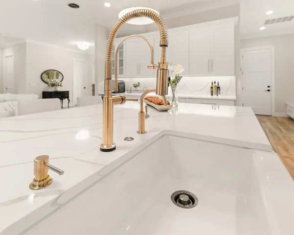 a kitchen with stainless steel appliances a refrigerator sink and stove