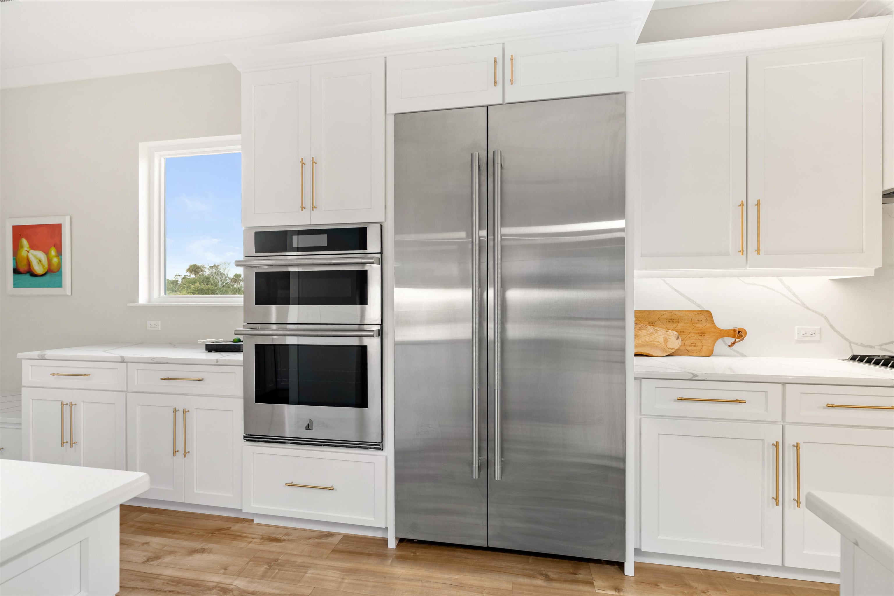 2549 Palm Avenue Flagler Beach, FL 32136 - Photo 13 of 65 a kitchen with cabinets stainless steel appliances and wooden floor