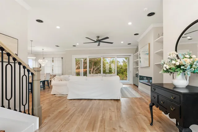 a living room with furniture fireplace and a large window