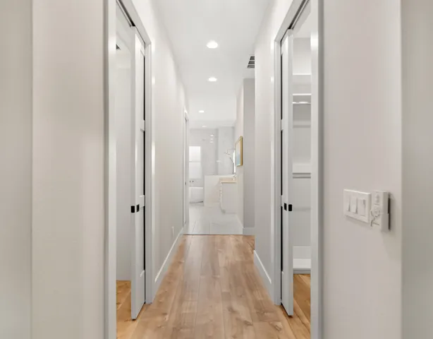 a spacious bathroom with a double vanity sink mirror and bathtub