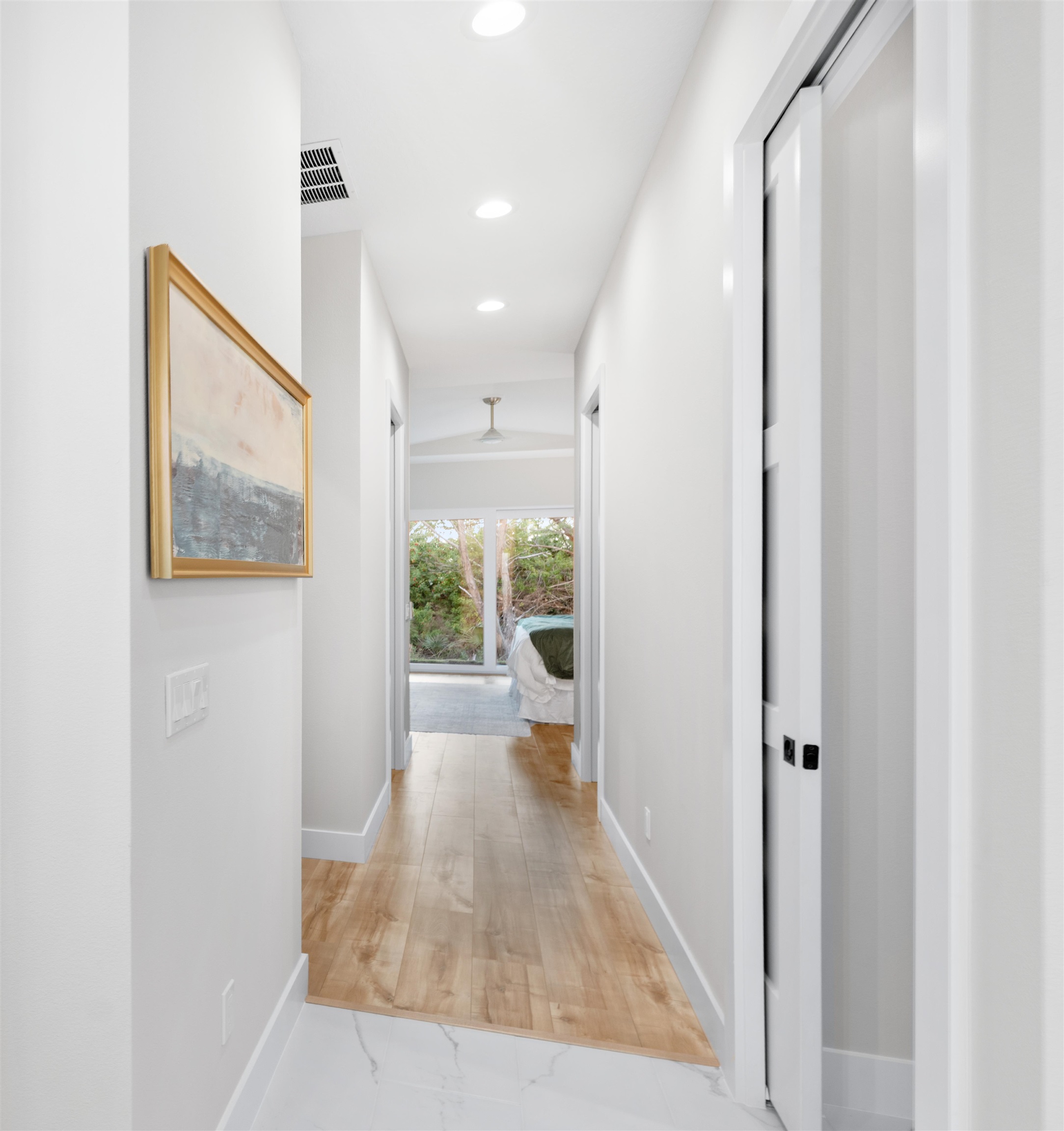 2549 Palm Avenue Flagler Beach, FL 32136 - Photo 27 of 70 a view of a hallway with wooden floor and a bathroom