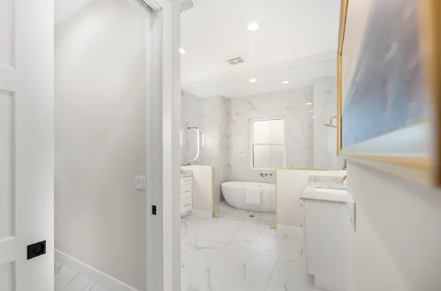 a bathroom with a granite countertop sink vanity and mirror