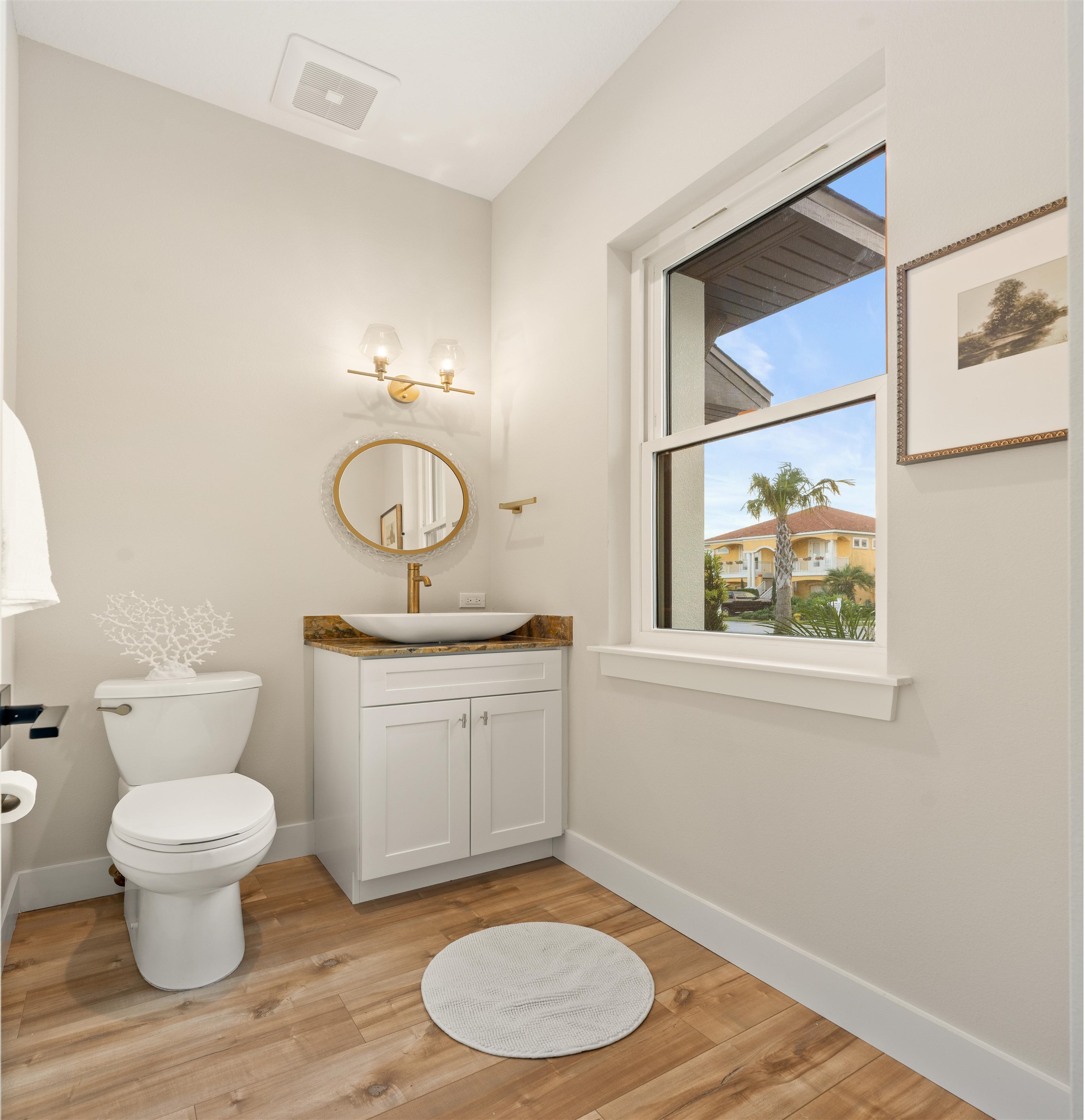 2549 Palm Avenue Flagler Beach, FL 32136 - Photo 29 of 70 a bathroom with a toilet a sink and mirror