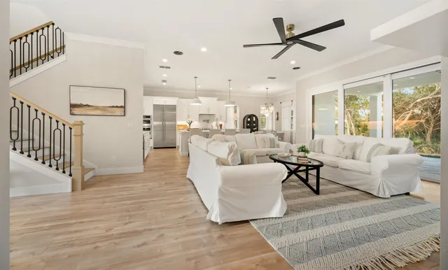 a living room with furniture and a view of kitchen