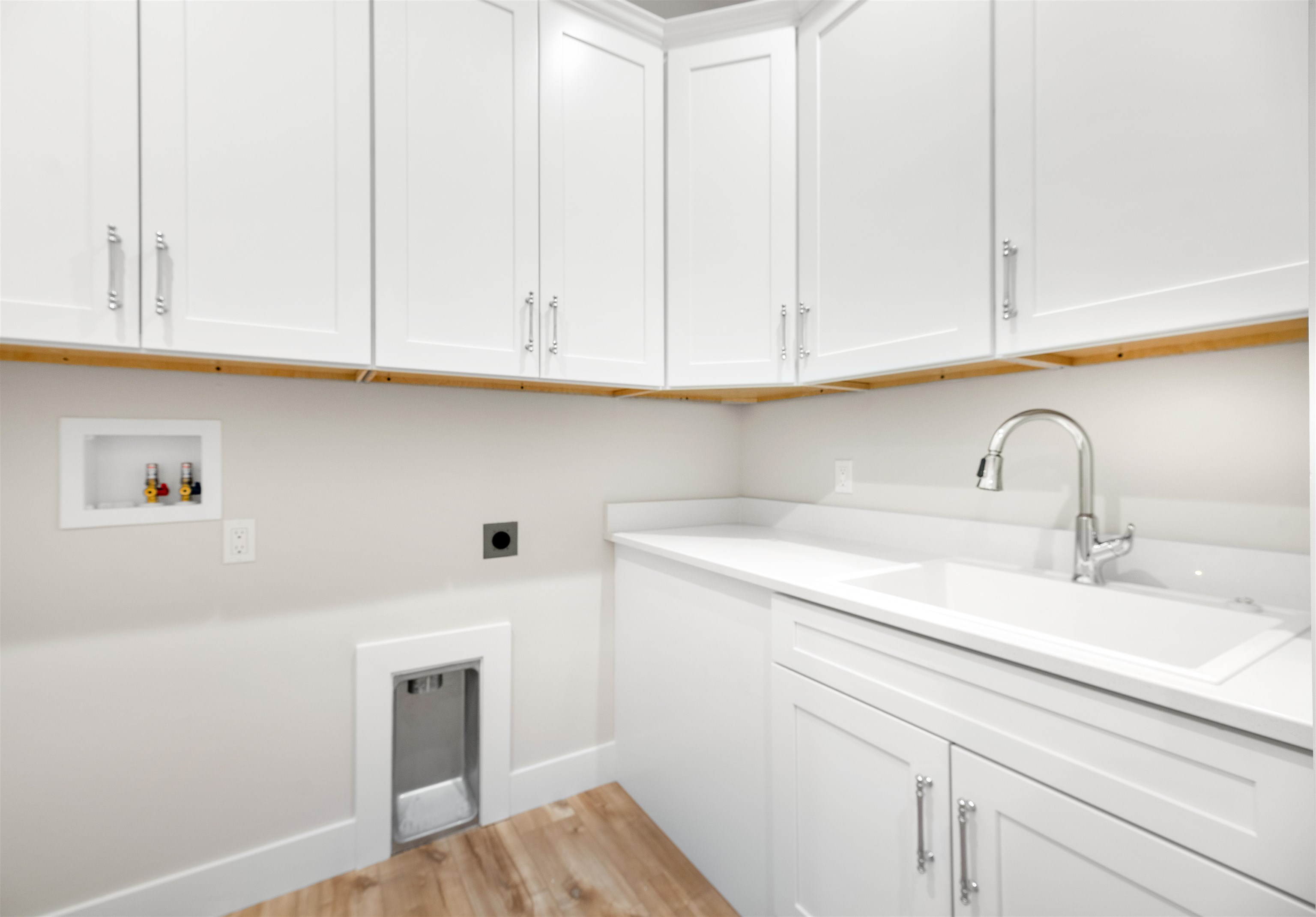 2549 Palm Avenue Flagler Beach, FL 32136 - Photo 39 of 70 Laundry area featuring cabinet space, light wood-type flooring, hookup for an electric dryer, and hookup for a washing machine