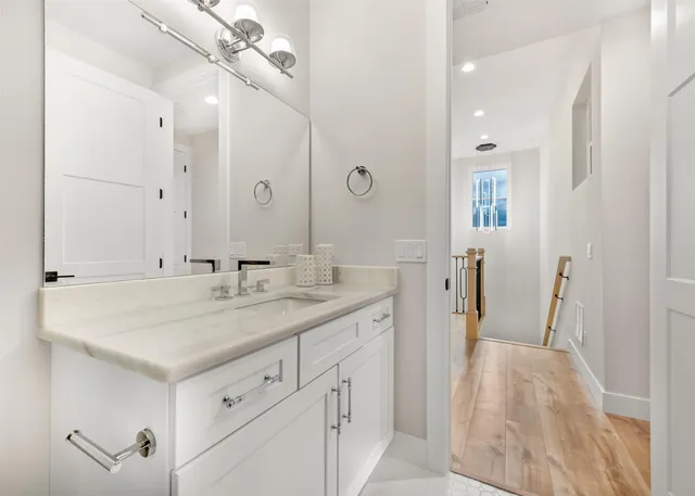 a bedroom with two beds and painting on the wall