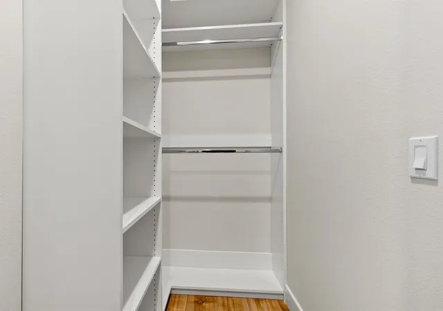 a kitchen with granite countertop a sink cabinets and wooden floor