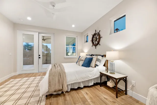 a front view of a house with a lots of windows and plants