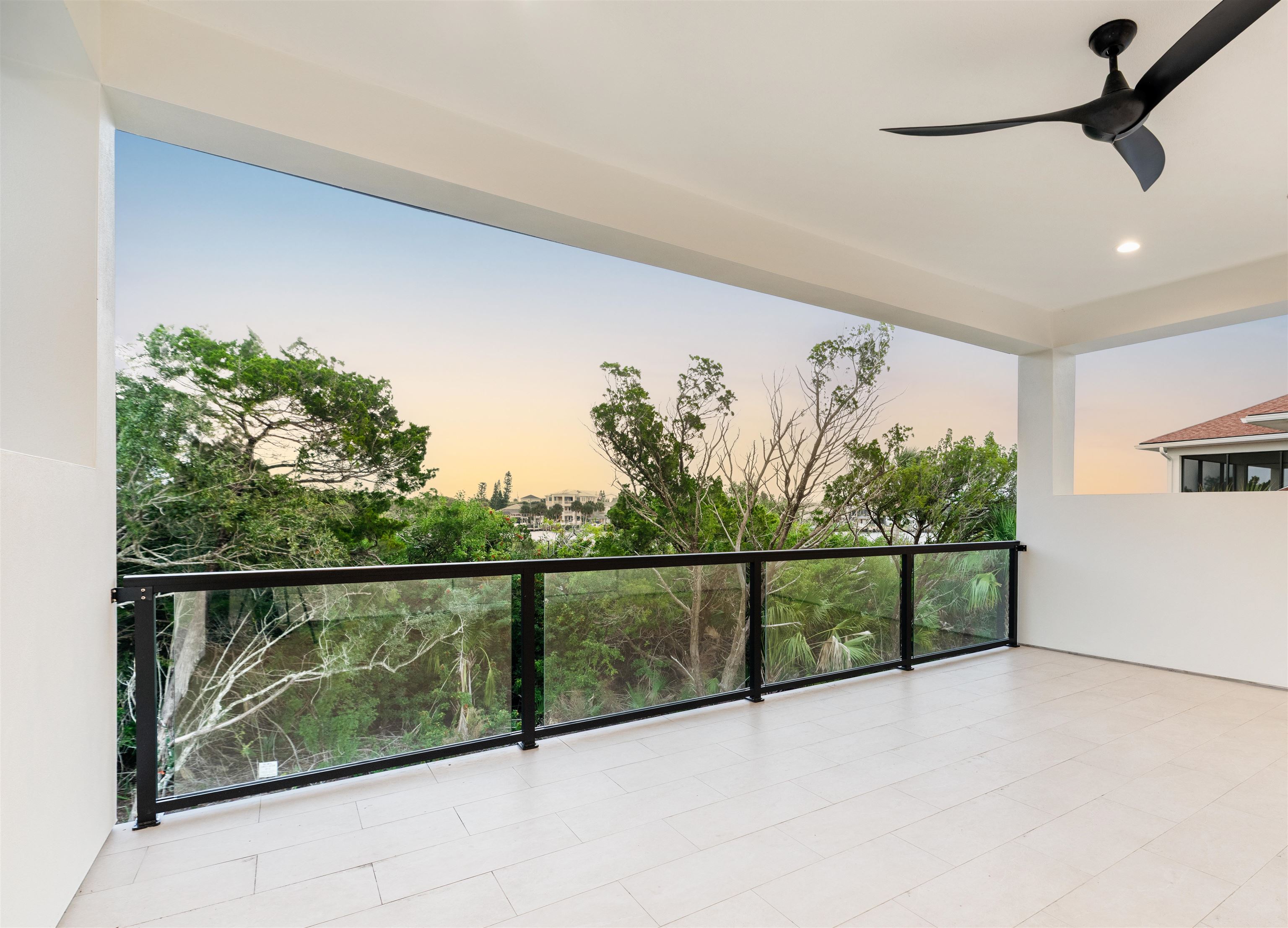 2549 Palm Avenue Flagler Beach, FL 32136 - Photo 49 of 65 Balcony at dusk with a ceiling fan and a patio area