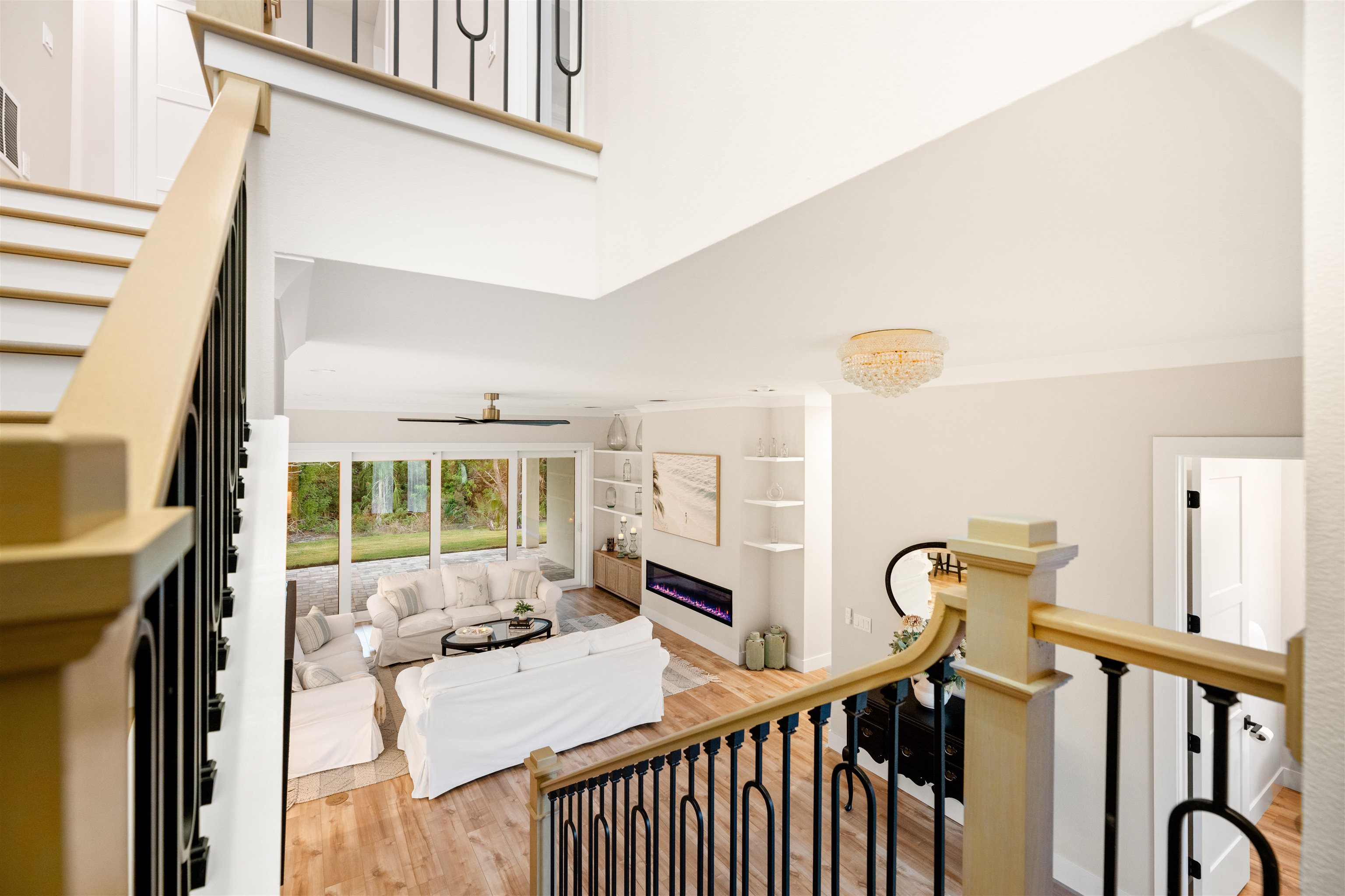 2549 Palm Avenue Flagler Beach, FL 32136 - Photo 54 of 70 Living area featuring a towering ceiling, light wood-style floors, stairway, and built in shelves