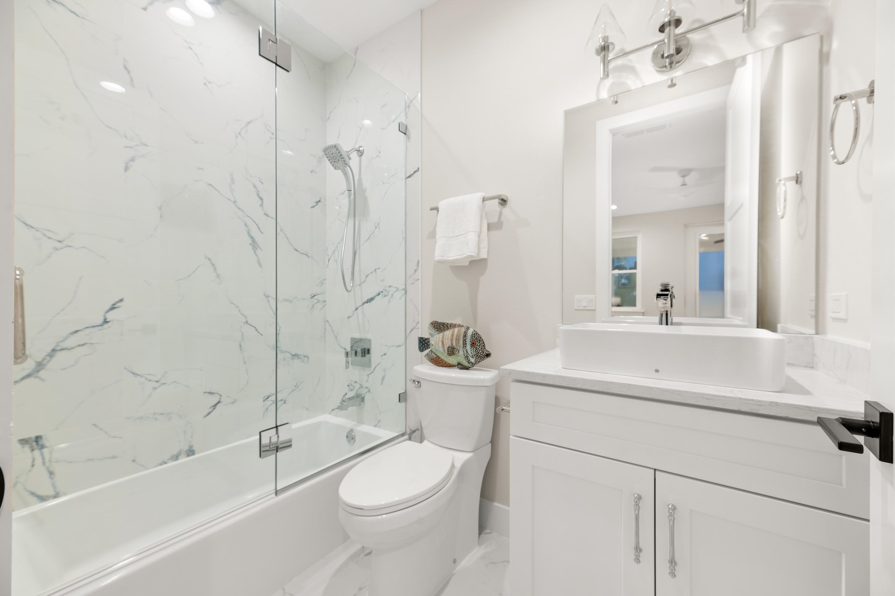 2549 Palm Avenue Flagler Beach, FL 32136 - Photo 58 of 70 a bathroom with a sink a toilet and a large mirror