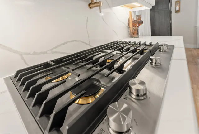 a kitchen with cabinets stainless steel appliances and wooden floor