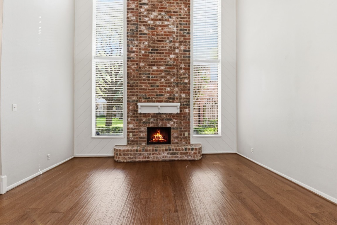 727 Bunker Hill Road, Unit 34 Houston, TX 77024 - Photo 11 of 50 Airy living room with soaring brick fireplace