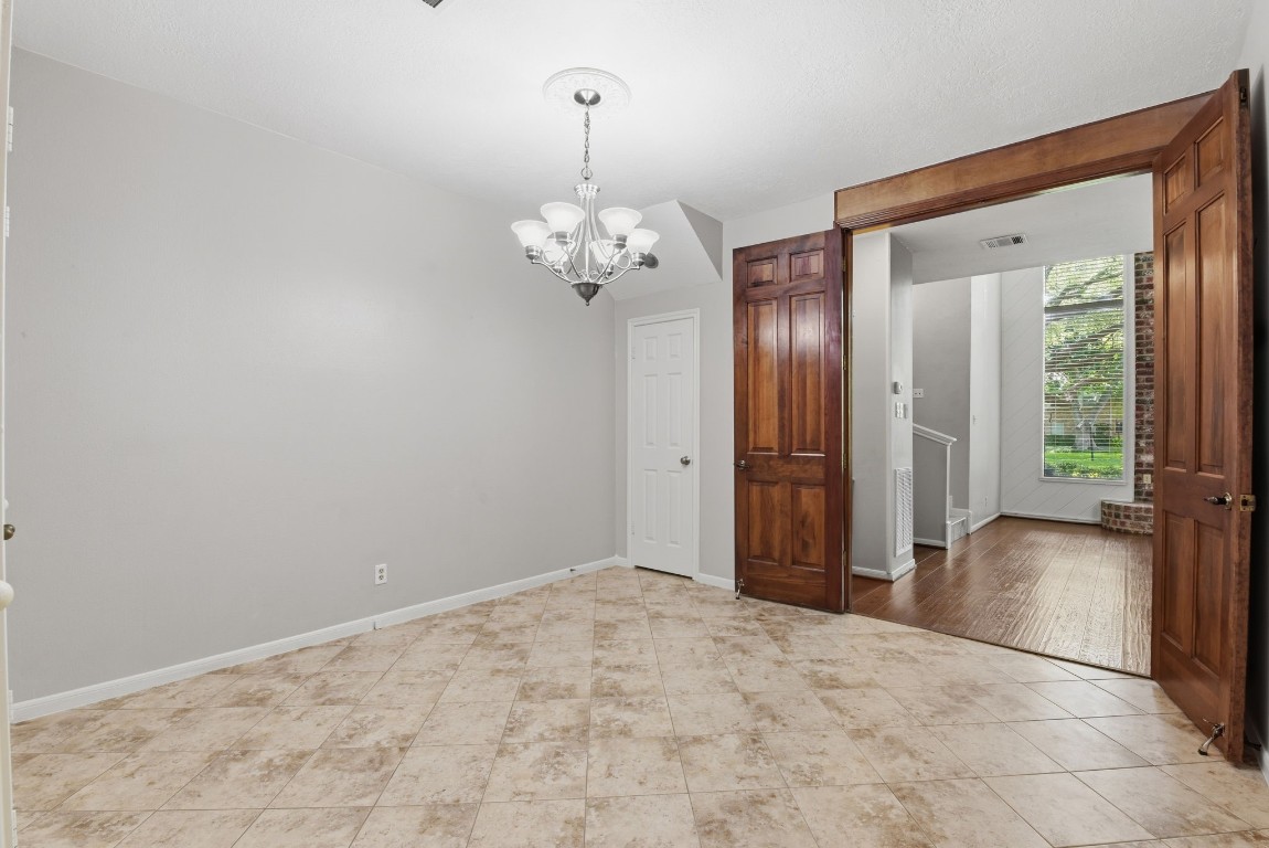 727 Bunker Hill Road, Unit 34 Houston, TX 77024 - Photo 15 of 50 Living room and formal dining room connected seamlessly via elegant wood-trimmed French doors