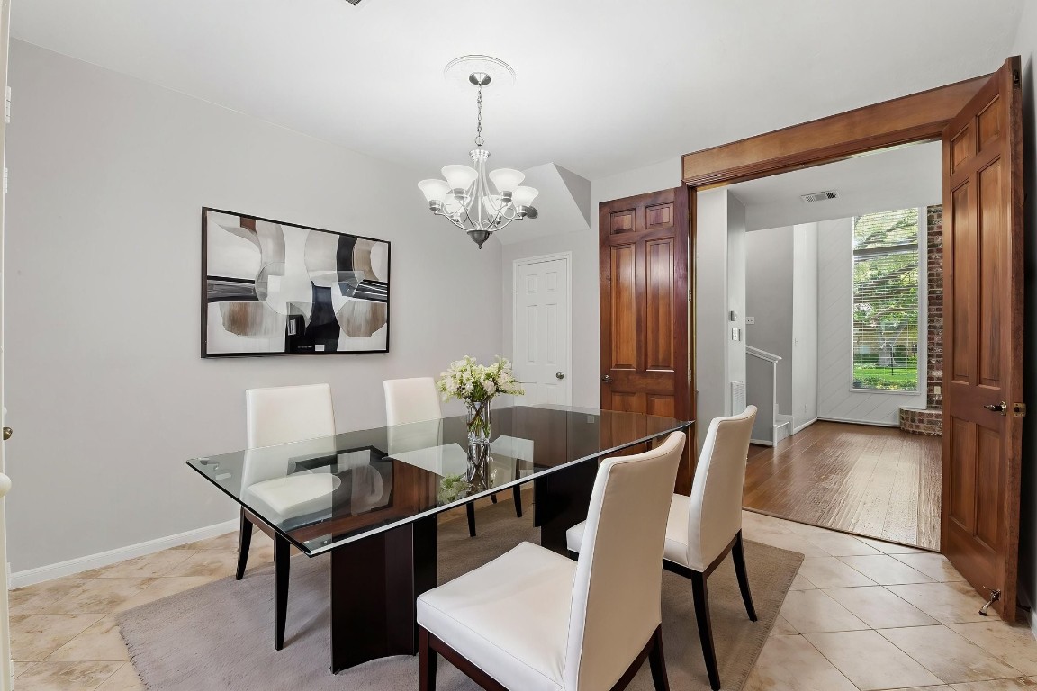 727 Bunker Hill Road, Unit 34 Houston, TX 77024 - Photo 16 of 50 Elegant dining room with wood-trimmed French doors, and abundant natural light (virtually staged)