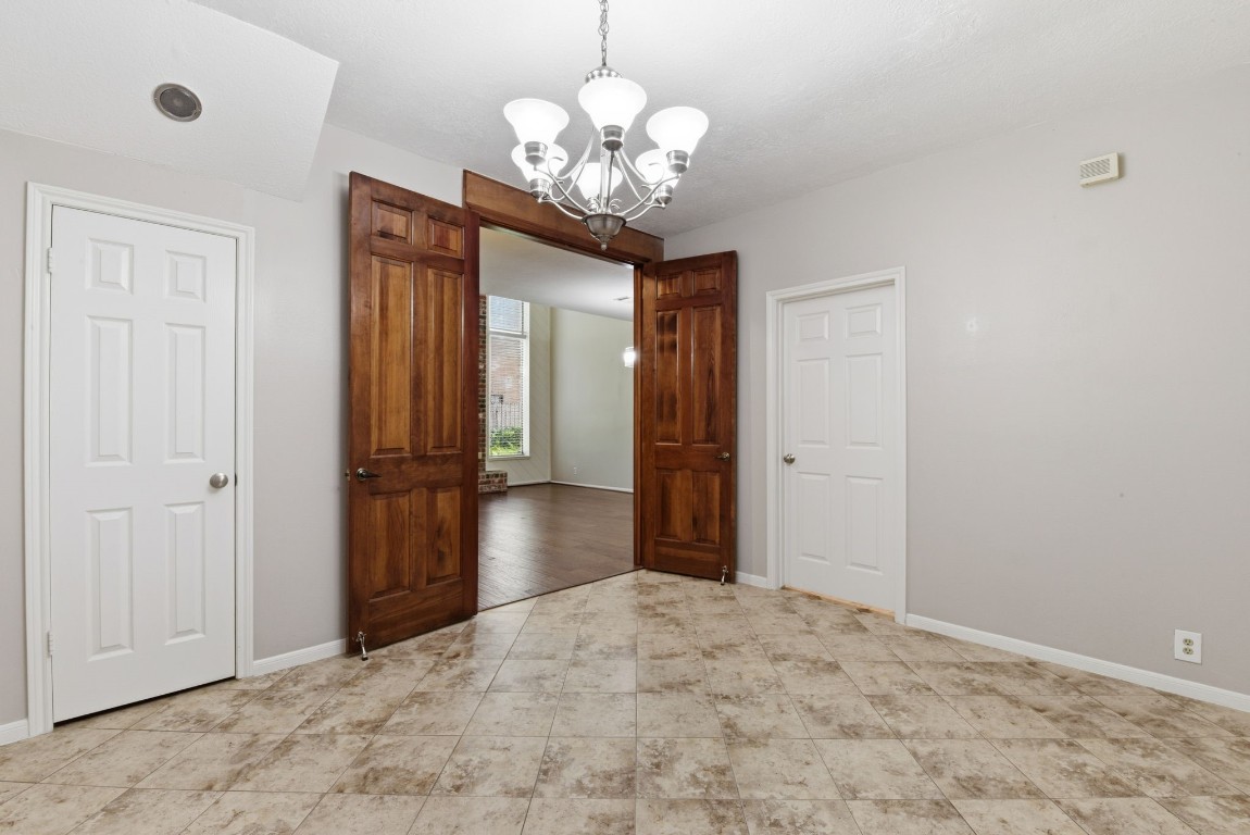 727 Bunker Hill Road, Unit 34 Houston, TX 77024 - Photo 17 of 50 View from formal dining room through elegant wood-trimmed French doors into the living room