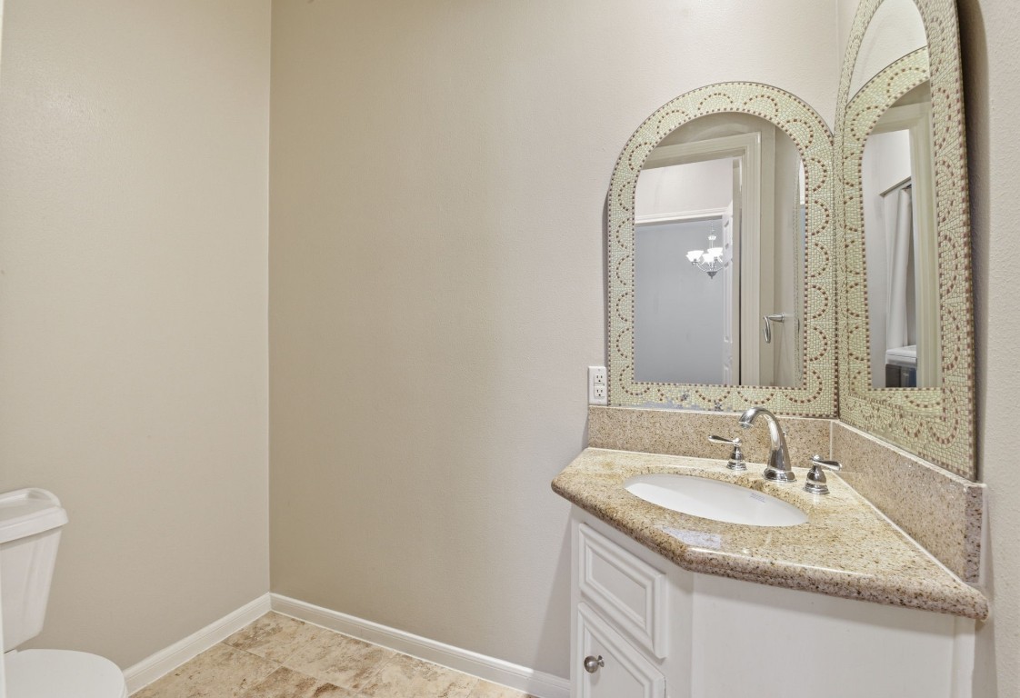 727 Bunker Hill Road, Unit 34 Houston, TX 77024 - Photo 23 of 50 Bright guest bathroom with arched mirror, white vanity, and tile floors