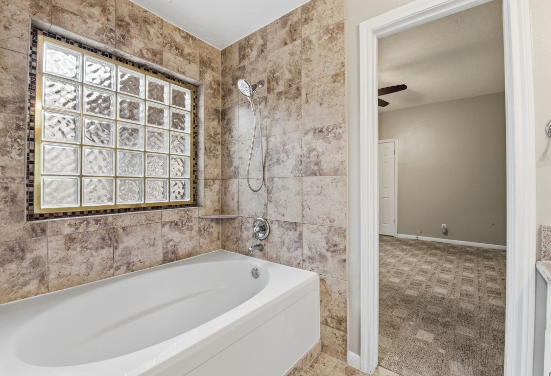 727 Bunker Hill Road, Unit 34 Houston, TX 77024 - Photo 31 of 50 Primary bathroom featuring shower and tub combo with glass block window