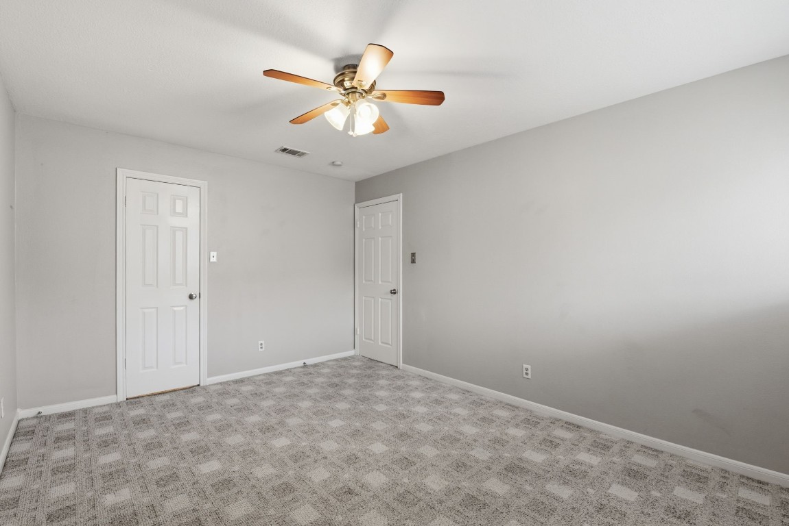 727 Bunker Hill Road, Unit 34 Houston, TX 77024 - Photo 39 of 50 Generously sized upstairs bedroom with ceiling fan, neutral carpet, and plenty of storage