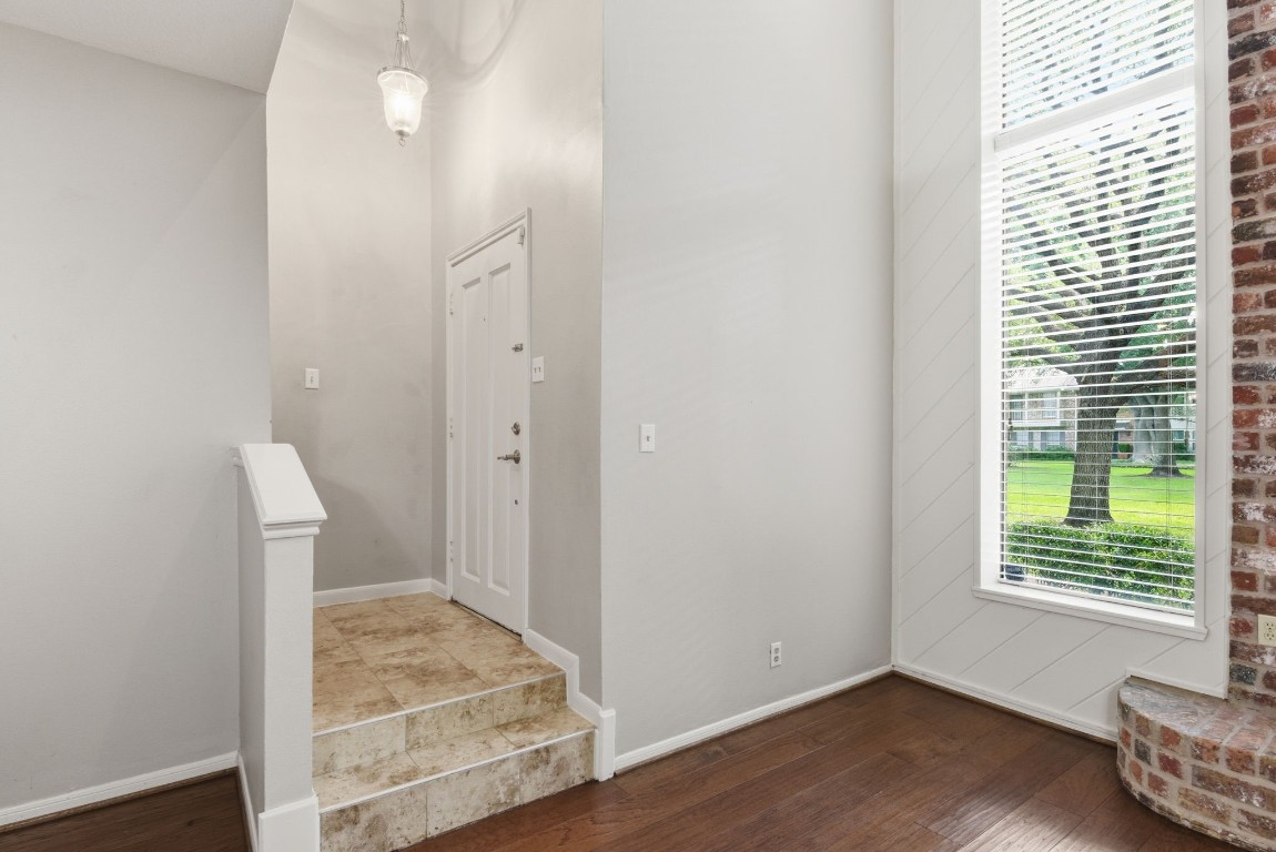 727 Bunker Hill Road, Unit 34 Houston, TX 77024 - Photo 4 of 50 Sun-drenched foyer with rich hardwood floors and oversized windows