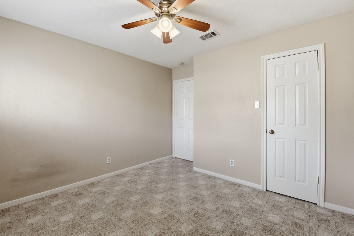 727 Bunker Hill Road, Unit 34 Houston, TX 77024 - Photo 43 of 50 Spacious upstairs bedroom with ceiling fan, neutral carpet, and generous closet space