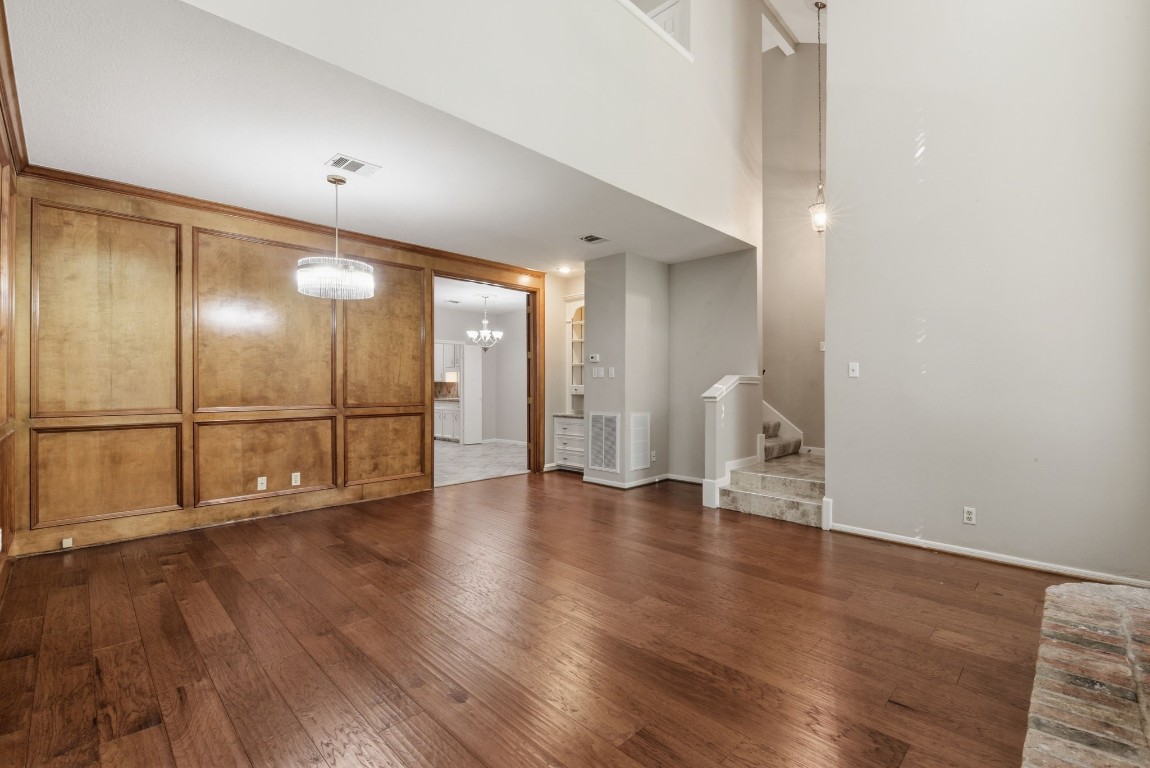 727 Bunker Hill Road, Unit 34 Houston, TX 77024 - Photo 8 of 50 Elegant wood-paneled wall detail with rich hardwood floors and soaring ceilings