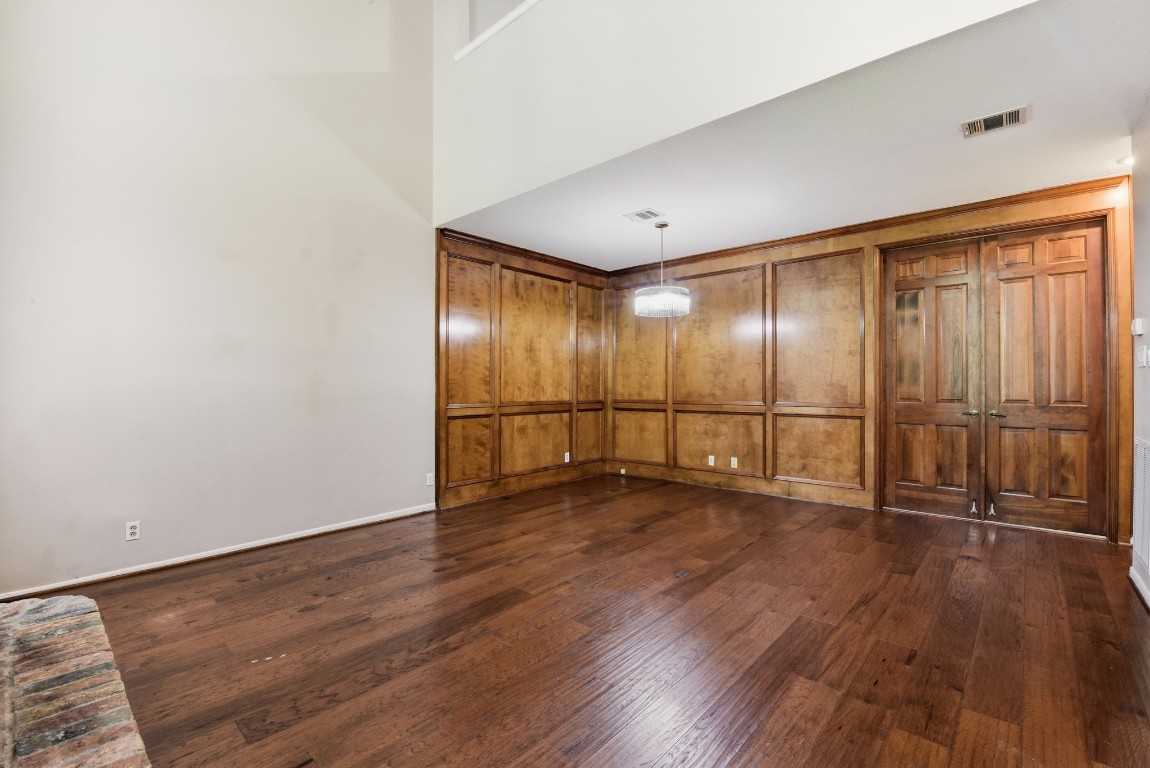 727 Bunker Hill Road, Unit 34 Houston, TX 77024 - Photo 9 of 50 Open living area showcasing stunning floor-to-ceiling wood paneling, gleaming hardwood floors, and classic French doors