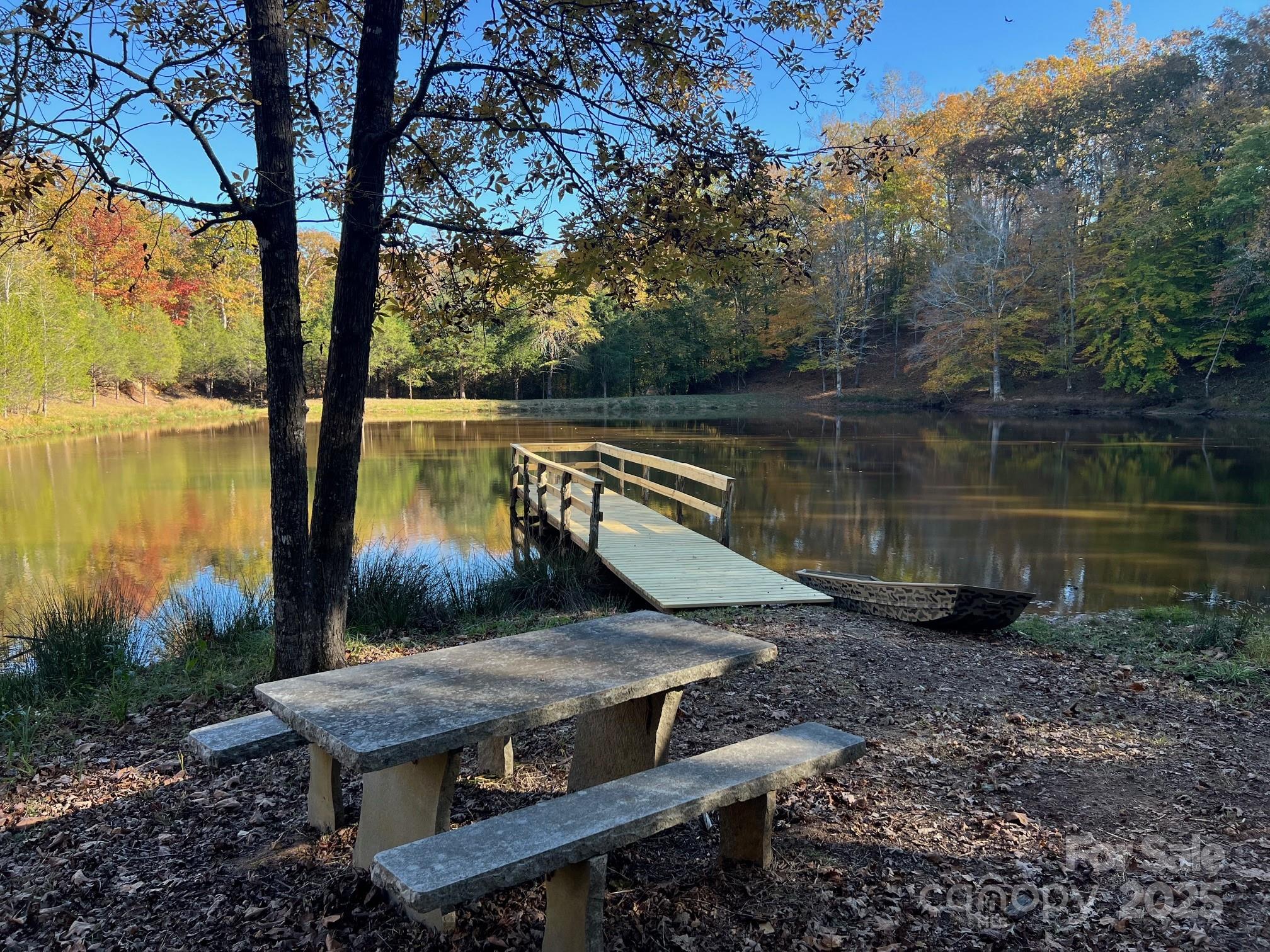 a view of a wooden deck with a lake