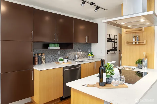 a kitchen with a sink a stove and chairs