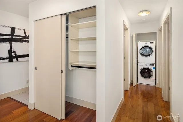 a view of a hallway with wooden stairs
