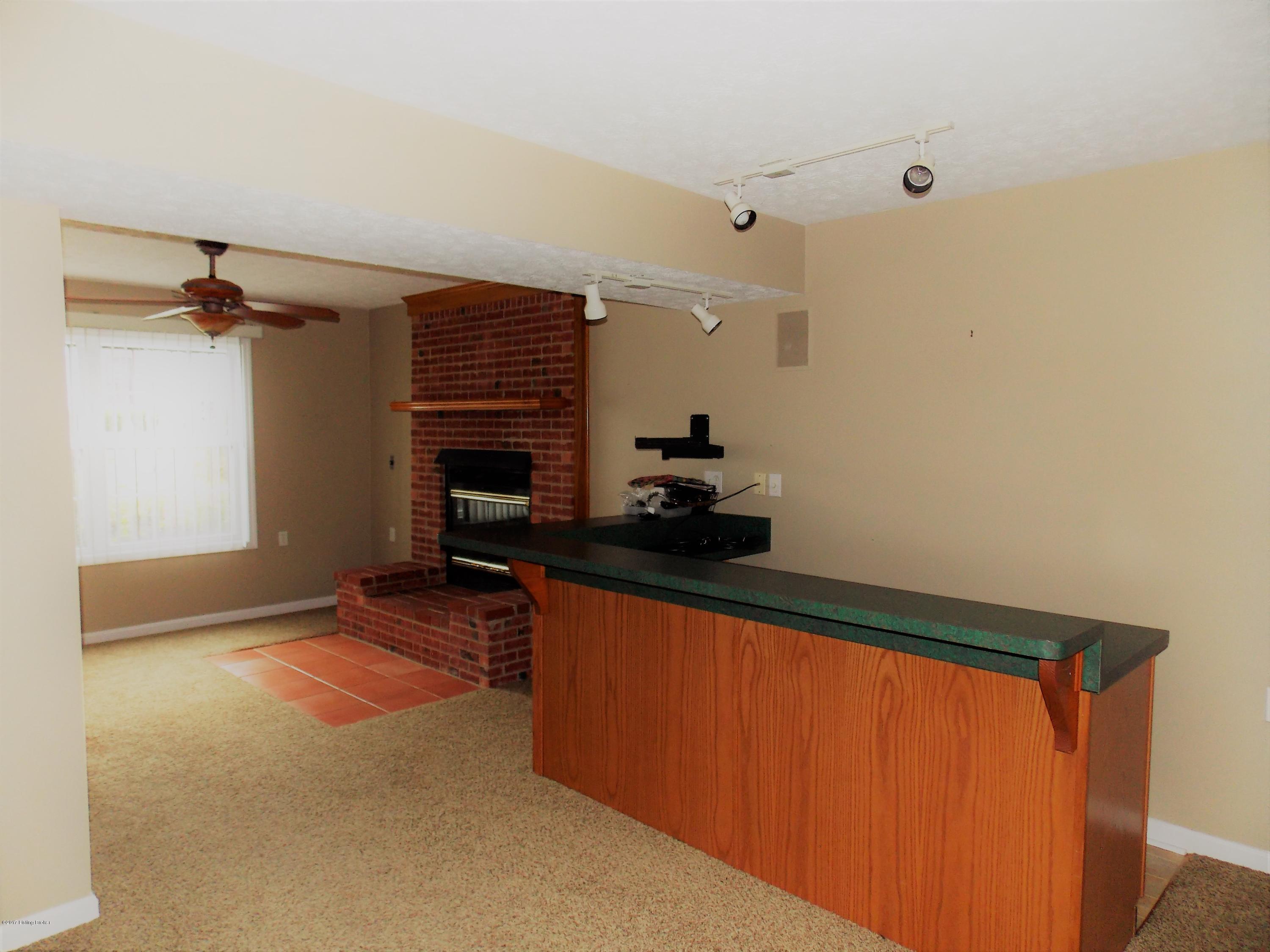 7306 Ridge Creek Road Louisville, KY 40291 - Photo 34 of 53 View of bar/entertainment area looking into family room with fireplace.