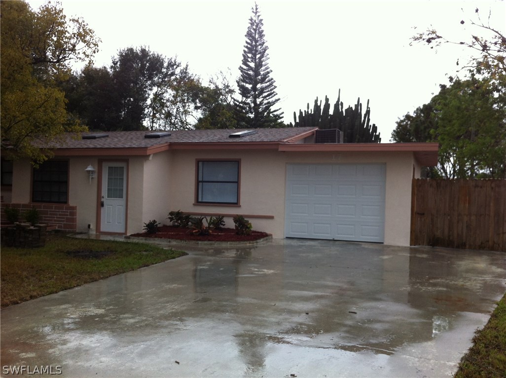 17 Iowa Road Lehigh Acres, FL 33936 - Photo 1 of 18 a front view of a house with yard